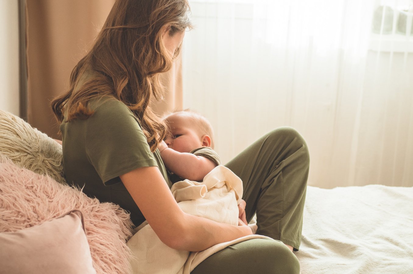 Portrait of mom and breastfeeding baby.